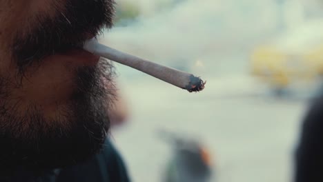 Bearded-man-lights-and-smokes-cigarette-in-slow-motion