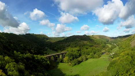Aerial-view,-footage-of-Headstone-Viaduct-in-Bakewell,-Derbyshire,-the-Peak-District-National-Park,-on-a-beautiful-cloud-filled-Summers-day,-commonly-used-by-cyclists,-hikers,-popular-with-tourists