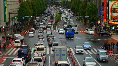 Tokyo-Japan---Circa-Time-lapse-pan-shot-o-busy-crossing-in-Shinjuku-with-many-pedestrians,-cars,-bilboards,-daylight-situation