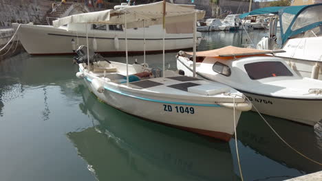 Small-boats-moored-up-next-to-the-Ancient-Old-Town-walls-of-Zadar