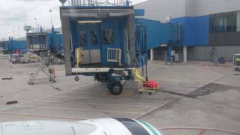 Sitting-on-a-plane-looking-out-the-window-at-the-departure-gate,-ramp