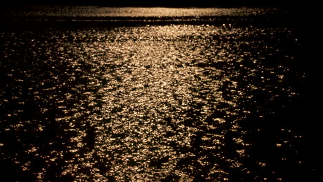 Evening-sunlight-reflecting-off-a-lake,-slow-motion,-abstract