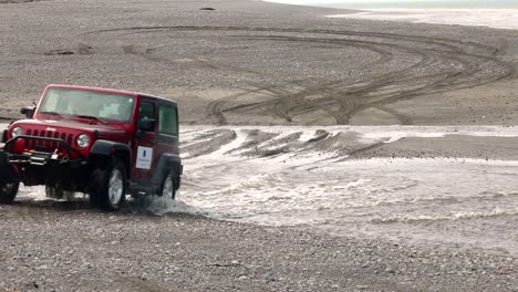 Jeep-Wrangler-crossing-a-creek-on-the-beach-on-Cooks-Inlet-on-the-Kenai-Peninsula-of-Alaska