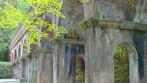 Brick-bridge-surrounded-by-beautiful-trees-in-the-background-in-Kyoto,-Japan-soft-lighting-4K