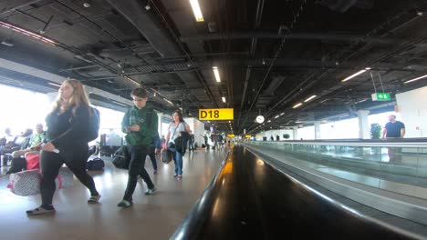 People-traveling-with-luggage-inside-an-airport