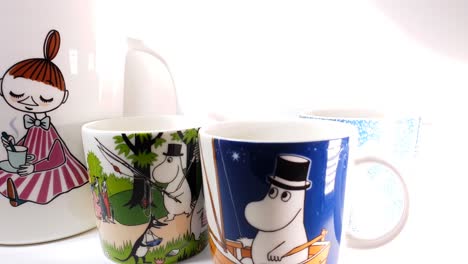 Ceramic-Mugs-with-Moomin-print-on-white-background,-Playful-Finnish-design