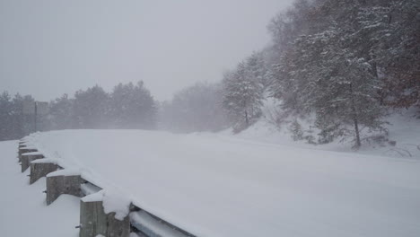 A-pickup-truck-drives-through-heavy-snow-on-a-rural-Wisconsin-road