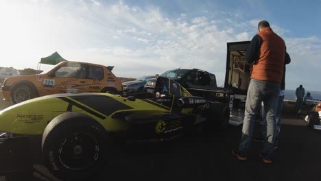 Yellow-Race-Car-Parked-Near-Trailer-At-The-Hill-In-Imtahleb-Malta---medium-shot