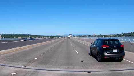 Driving-on-highway-surrounded-with-water-surface-in-Vancouver