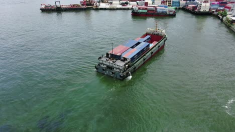 Small-Feeder-class-Container-ship-in-Hong-Kong-bay,-Aerial-view