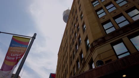 Looking-up-shot-of-buildings-and-Sydney-Tower-while-walking-around-Sydney-CBD-shopping-district