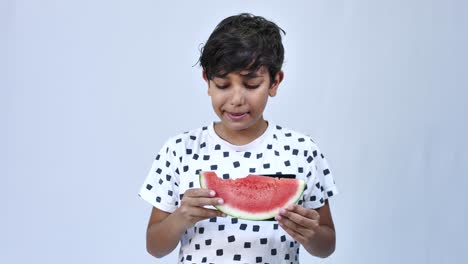 Cheerful-boy-eating-watermelon,-isolated-on-white-background