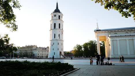 Distant-people-walking-past-Vilnius-city-cathedral-and-bell-tower-in-the-capital-of-Lithuania