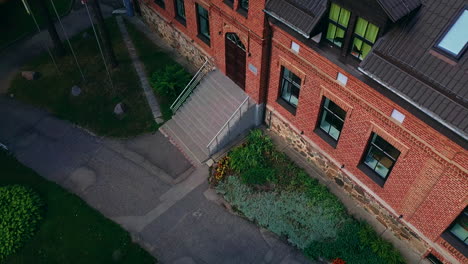 Aerial-view-of-Smiltene-High-School,-boom-up-tilt-down,-Latvia