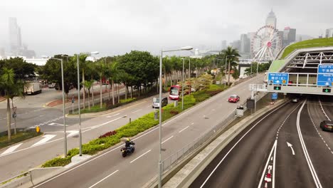 Traffic-passing-in-downtown-Hong-Kong,-Low-angle-aerial-view