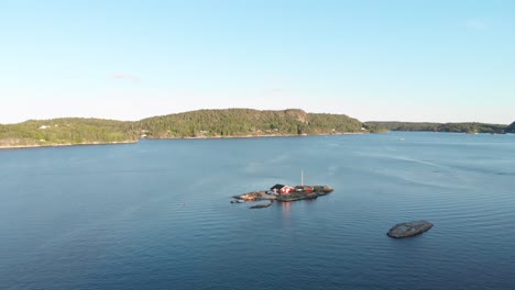 Beautiful-fishing-cabin-on-remote-Norwegian-island,-aerial-view