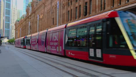 Sydney-Light-Rail-Tram-travelling-pass-QVB-Building-at-Sunset