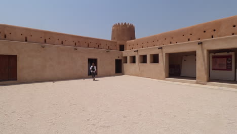 Tourist-walking-through-the-center-courtyard-of-the-Al-Zubara-Fort-in-Qatar