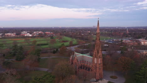 An-aerial-shot-of-a-beautiful-cathedral-with-a-tall-steeple-during-sunrise