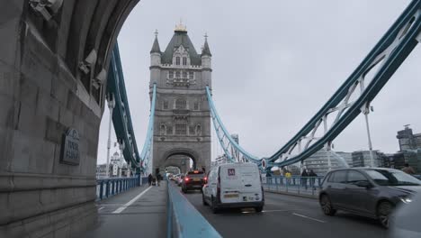 Cars-driving-on-tower-bridge-London-on-a-cloudy-day-from-side-of-road
