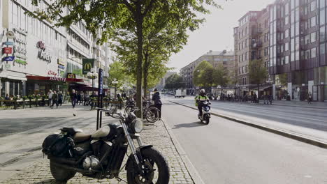 Static-view-of-tram,-scooter-and-bicycle-traffic-on-Avenyn,-Gothenburg