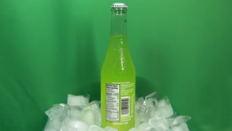 2-3-Jarritos-Lime-Drink-Bottle-Rotating-360-degrees-on-stacked-ice-in-front-of-green-screen