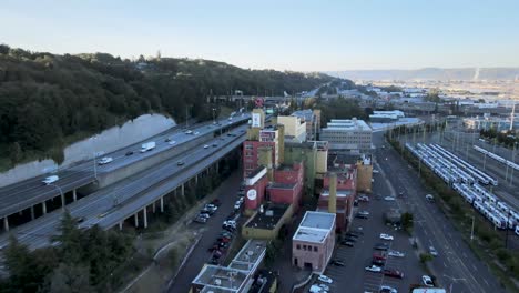 Approaching-the-Old-Rainier-Beer-Brewery-as-traffic-moves-along-interstate-5,-aerial