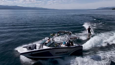 Wakeboarding-behind-speedboat-on-Flathead-Lake,-Montana,-aerial-view