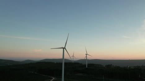Wind-Turbines-Of-Electric-Generators-During-Sunset-With-Mountain-Silhouette-In-Serra-de-Aire-e-Candeeiros,-Leiria-Portugal