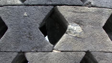 Zooming-out-from-Buddha's-face-inside-of-a-stupa-at-Borobudur-Temple,-UNESCO-World-Heritage-Site,-Central-Java,-Indonesia,-Buddhist-Temple