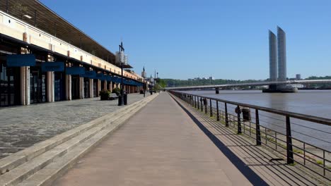 Cook-and-Go-restaurant-and-JCD-Bridge-on-the-Garonne-river-shore-closed-for-COVID-19-pandemic,-Stable-handheld-shot