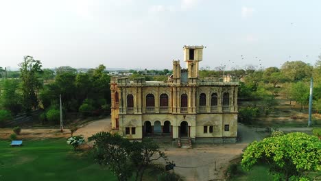 A-landscape-aerial-view-of-Chittorgarh-fort,-a-UNESCO-world-heritage-site,-Rajasthan,-India,-Fort-smog-over-city,-Aerial-view,-1