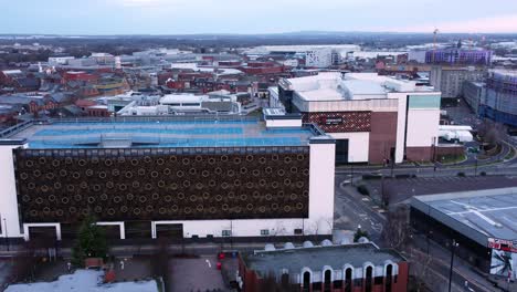 Early-morning-aerial-Warrington-England-city-street-multi-storey-carpark-rooftop-townscape-rising-zoom-in