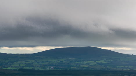 Time-lapse-of-countryside-landscape-with-hills-and-fields-on-a-cloudy-dramatic-day-in-rural-Ireland