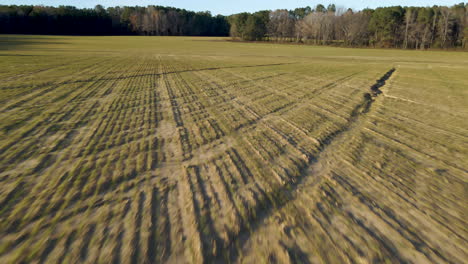 Drone-flying-low-over-farm-field-in-winter