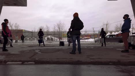 People-play-drums-outside-under-highway-overpass-in-the-cold-winter-air