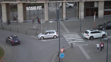 A-branch-of-fitness-chain-Basic-Fit-situated-at-a-busy-roundabout-with-passing-traffic-in-Brussels,-Belgium