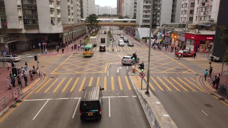 Time-lapse-of-People-crossing-the-street-in-Downtown-Hong-Kong,-Aerial-view