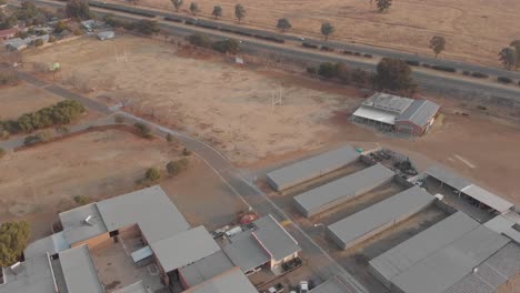 AERIAL-shot-over-a-school-next-to-a-national-road-during-winter