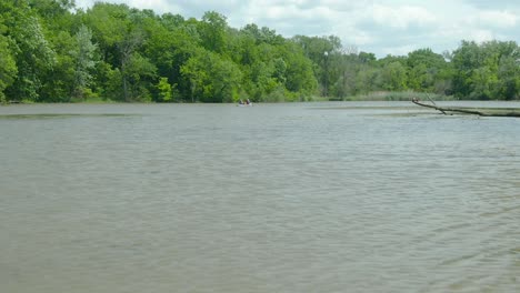 Low-altitude-drone-shot-of-people-on-kayaks-in-the-murky-waters-of-the-Illinois-and-Michigan-canal