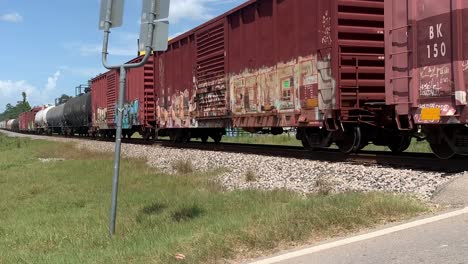 A-short-clip-of-a-fast-moving-train,-going-through-an-intersection,-in-the-middle-of-the-day