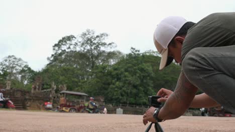 Asian-Man-Setting-up-GoPro-to-Take-Timelapse-at-Temple-Area