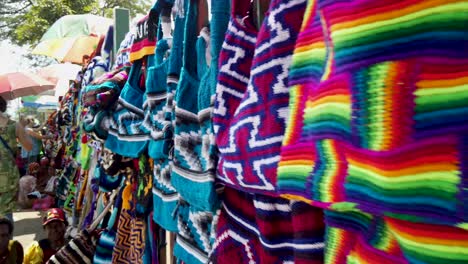 Walking-view-of-colorful-bilum-string-bags-hanging-on-wall-at-market