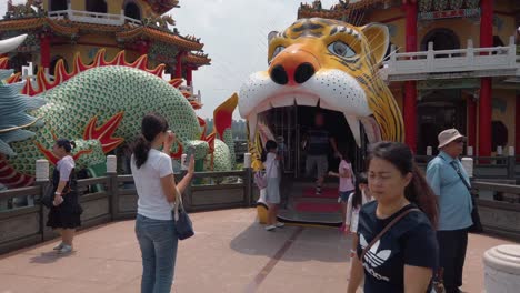 Tourists-pose-for-a-photograph-at-the-Dragon-and-Tiger-Pagodas-in-Kaohsiung,-Taiwan