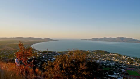 Hiker-Couple-watching-aerial-view-of-sunset-after-reaching-the-summit-at-sunset