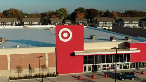 Aerial-push-in-on-entrance-of-Target-retail-store-and-logo,-shoppers-enter-and-exit