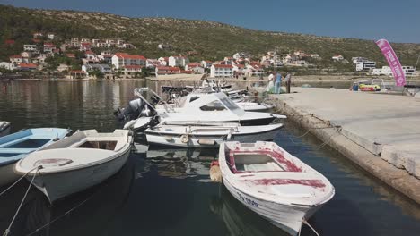 Fisherman-tends-to-his-nets-on-a-calm,-sunny-day-in-an-Adriatic-marina