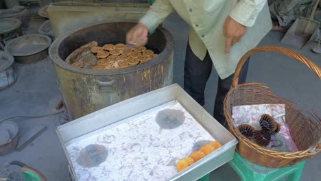 Man-taking-Khanom-Farang-Kudeejeen-cupcakes-out-of-oven-and-removing-paper-cups