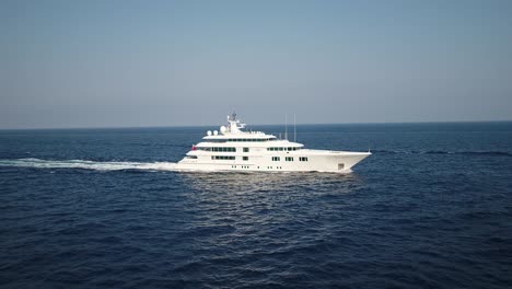 Aerial-slide-alongside-a-large-luxury-cruise-ship-on-a-blue-sea