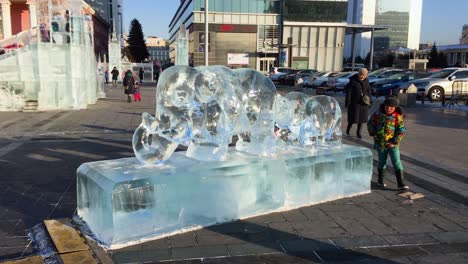 Curious-Children-Play-Near-Carved-Elephant-Ice-Sculpture
